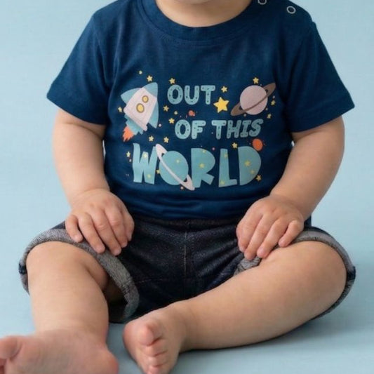 Child wearing a navy blue t-shirt with space-themed design on a light blue background