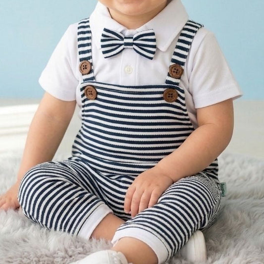 Child wearing a striped outfit with a bow tie against a light blue background